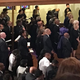 Michelle Obama stands behind former attorney general Eric H. Holder Jr. at services for Gwen Ifill in Washington on Nov. 19. (Credit: Sarah Glover)